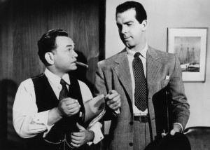 Canny claims adjuster Barton Keys (Edward G. Robinson) relays his suspicions to Neff.